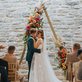 triangular pyramid beach wedding arch flowers florist dorset bride and groom